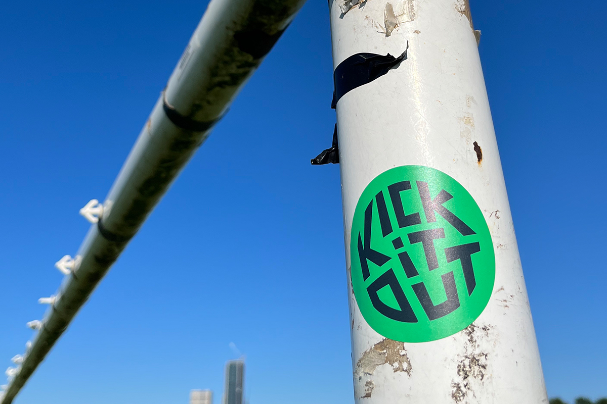 Kick It Out sticker on goal post