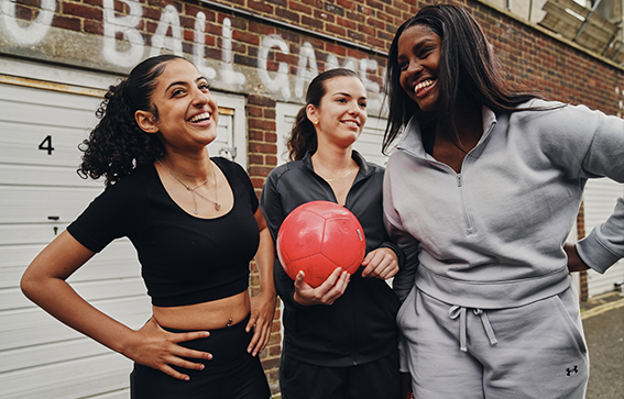 three people with a football